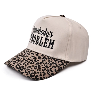 Off-white trucker hat with leopard print brim featuring Somebody's Problem embroidery