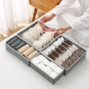 Foldable grey fabric organizer set for underwear and socks in a bedroom closet storage setup