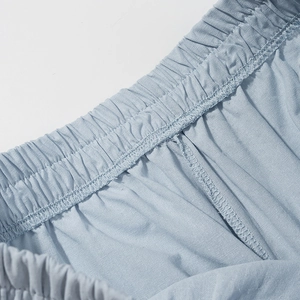 Detailed close-up of light blue elastic waistband with professional stitching and texture