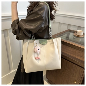 Borsa tote capiente in pelle PU beige e verde con tracolla a catena e ciondolo peluche