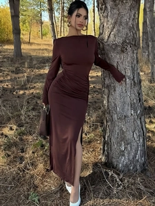 Detail of slim-fit brown pleated dress featuring a high side slit and soft knit texture