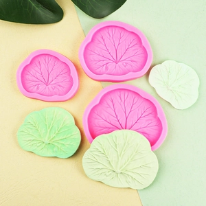 Pink leaf-shaped silicone fondant molds with realistic vein textures for cake decoration