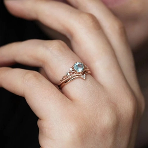 Exquisite rose gold crown ring set with blue round gemstone and pavé zircon stones