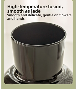 Macro shot of polished black ceramic vase rim showing smooth hand-finished texture