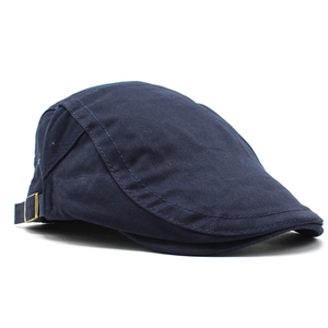 Detail view of navy cotton flat cap showing adjustable metal buckle and neat stitching