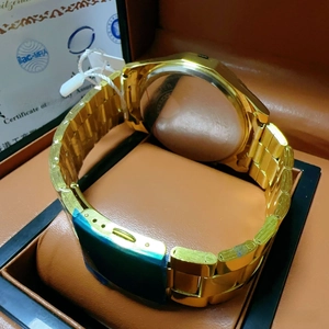 Detail view of gold stainless steel watch band and folding clasp on luxury watch