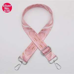Detail of adjustable pink marble pattern bag strap with silver metal lobster clasps