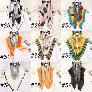 Grid display of nine satin square scarves with various floral and geometric patterns