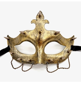 Detail of vintage punk half mask with bronze finish, metallic spikes and hanging chains