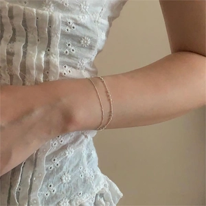 Close-up of double-layered 925 sterling silver beaded bracelet worn on a female wrist