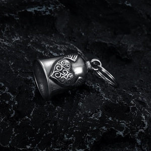 Detail of silver stainless steel motorcycle bell with embossed heart and wings design
