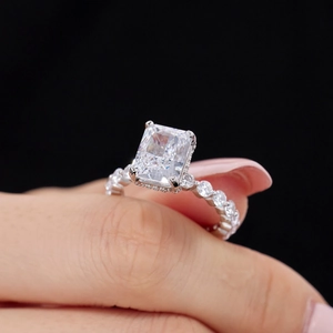 Detailed close-up of a silver ring featuring a large rectangular zircon and round side stones