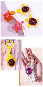Detailed view of colorful turtle resin keychains with tassels on bag and hand