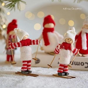 Handcrafted wooden skiing Santa figurine with red knitted outfit and festive bokeh backdrop