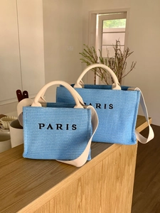Blue woven straw tote bags with Paris embroidery and cream long shoulder straps in two sizes