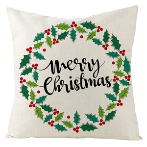 Detail of linen Christmas pillow case with holly wreath and Merry Christmas text