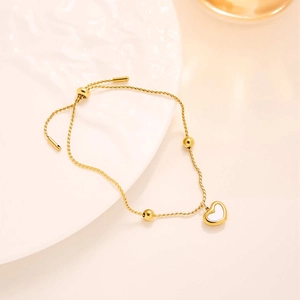 Close-up of heart pendant necklace with white shell inlay and adjustable gold chain