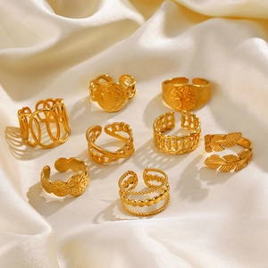 Set of 8 gold stainless steel adjustable rings featuring tree of life and leaf patterns