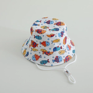 Close-up of children's cotton bucket hat with colorful fish print and adjustable chin strap