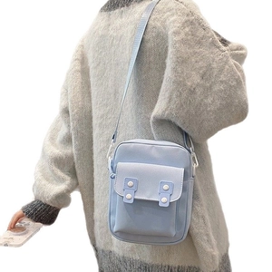 Simple light blue canvas crossbody bag for women with flap pocket and white buttons