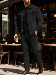 Detail of premium black faux suede fabric on a casual men's jacket and trouser set