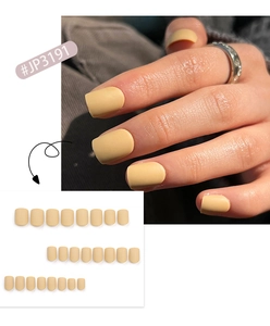 Detailed view of matte yellow short press-on nails on hand and as separate pieces