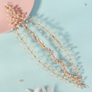 Handmade crystal pearl bridal headband with gold leaves and beads on a dual-tone background