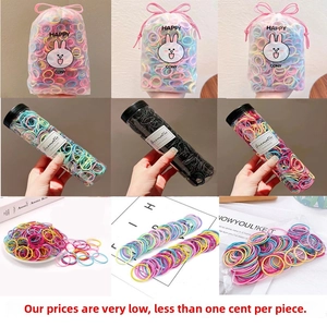 Close-up of assorted macaron colored elastic hair ties in various packaging for girls