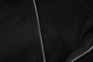 Detailed macro shot of high-quality black knit fabric texture and durable metal zipper