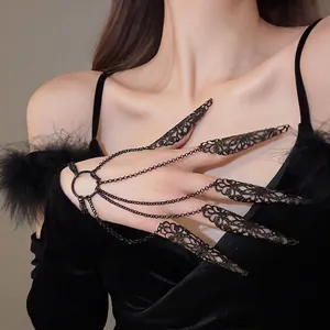 Exotic gothic hollow flower nail guards connected to a black metal ring bracelet
