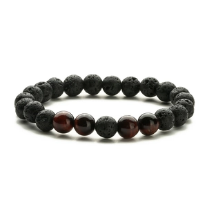 Close-up of 8mm black volcanic lava stones and polished tiger eye beads on an elastic bracelet