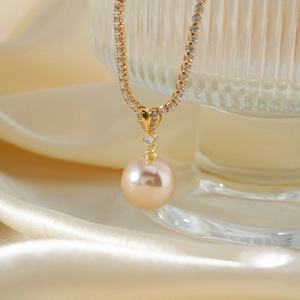 Elegant necklace with champagne pearl pendant and sparkling rhinestone chain on silk