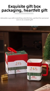 Detail of Christmas snowman ceramic square mug with matching decorative gift box and red handle