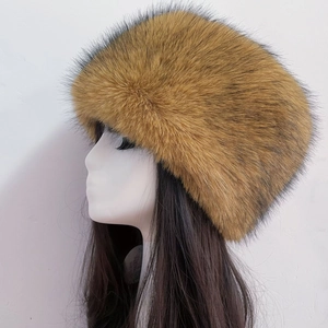 Detailed side view of thick brown faux fox fur Russian hat on a white background