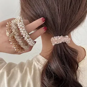 Crystal beads and pearls hair tie set with metal pendant shown on a model