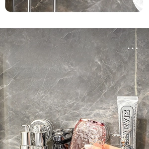 Close-up of wall-mounted metal holder with a pink hammer-texture glass rinsing cup