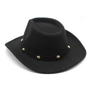 Detail of black felt cowboy hat featuring gold metal rivets on the decorative band