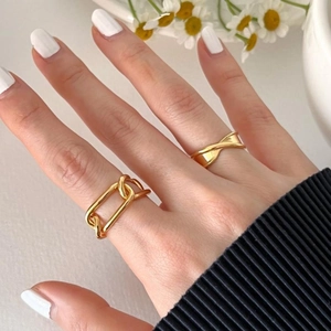 Set of two gold irregular stackable rings including chain and crisscross designs