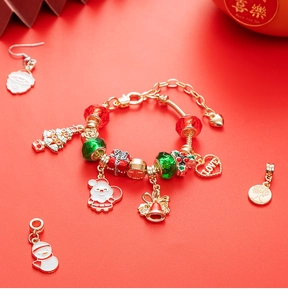 Detailed view of Christmas charm bracelet with festive red and green enamel pendants