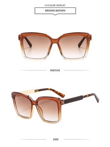Detalle de gafas de sol cuadradas de carey con lentes degradadas marrones y montura ámbar
