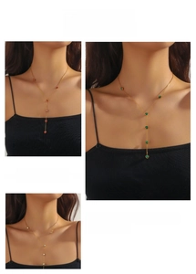Macro detail of Y-shaped necklace with colorful heart pendants in red and green colors