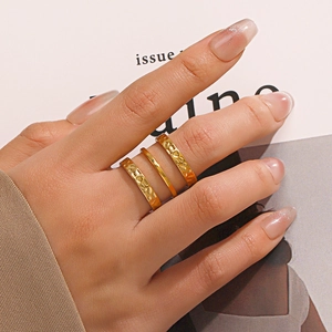 Three-piece 18K gold plated stainless steel stacked rings with hammered and smooth texture