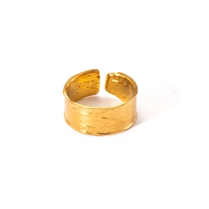 Macro shot of gold titanium wide ring featuring a hammered texture and adjustable open band