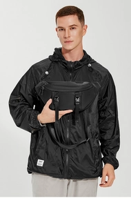 Detailed view of black tactical chest bag with dual buckle design and adjustable strap