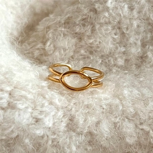 Minimalist gold-plated double-layer ring with an oval hollow design on soft fabric