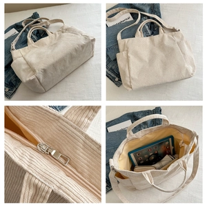 Detail view of beige corduroy tote bag showing large capacity and adjustable straps