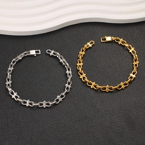 Detailed view of gold and silver stainless steel chain bracelets with unique link texture