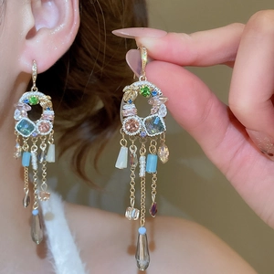Detailed close-up of French vintage long fringe earrings with colorful crystal tassels