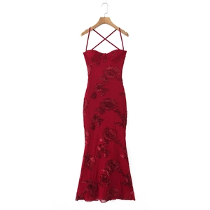 Detail view of red fishtail dress featuring 3D floral embroidery and lace-up back