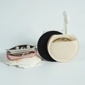 Microfiber jewelry pouches in grey, pink, black, and beige with pearl earrings